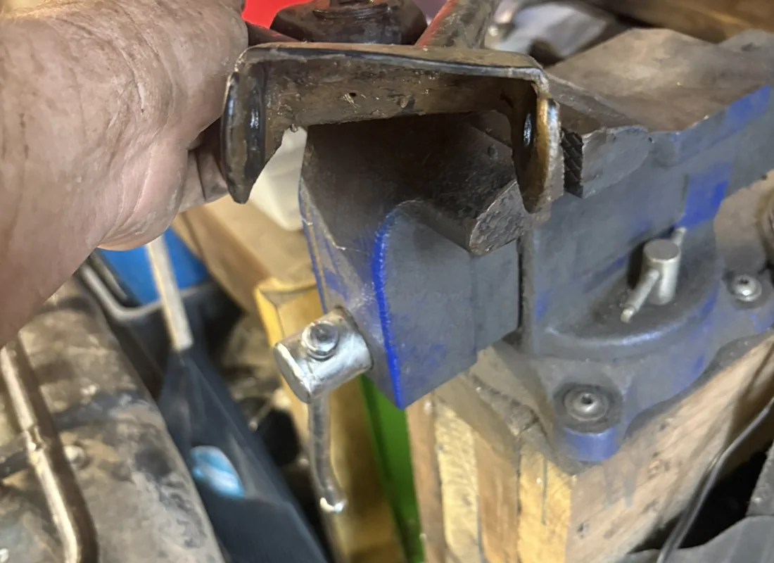 Fabricated metal bracket in a shop vise